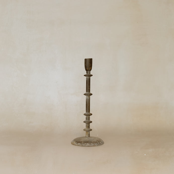 Bronze candlestick on a beige background