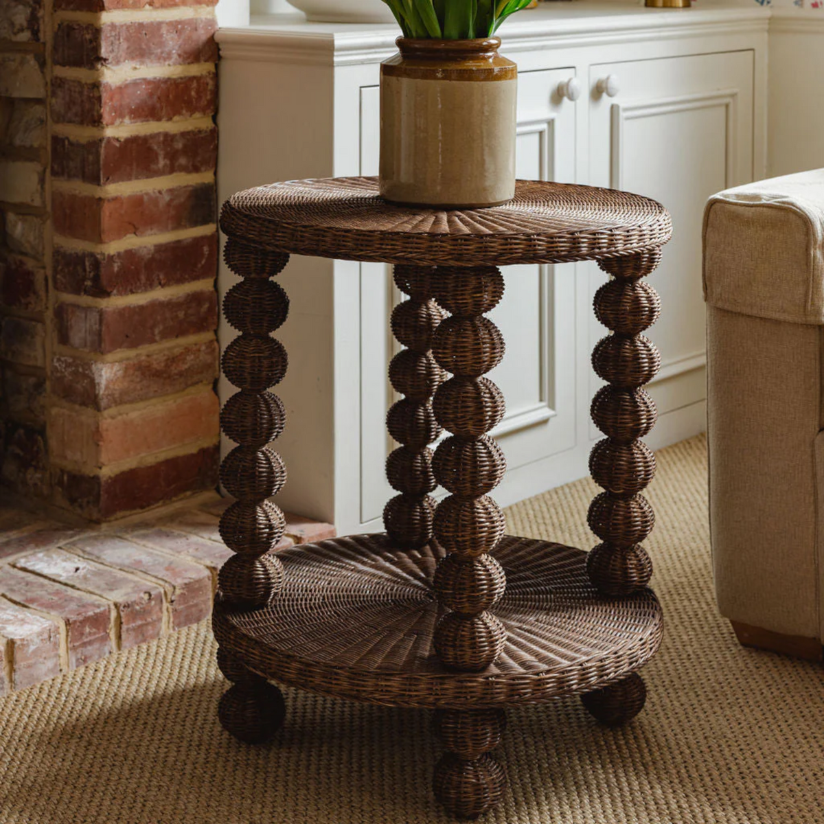 Wicker side table with decorative design in a home setting