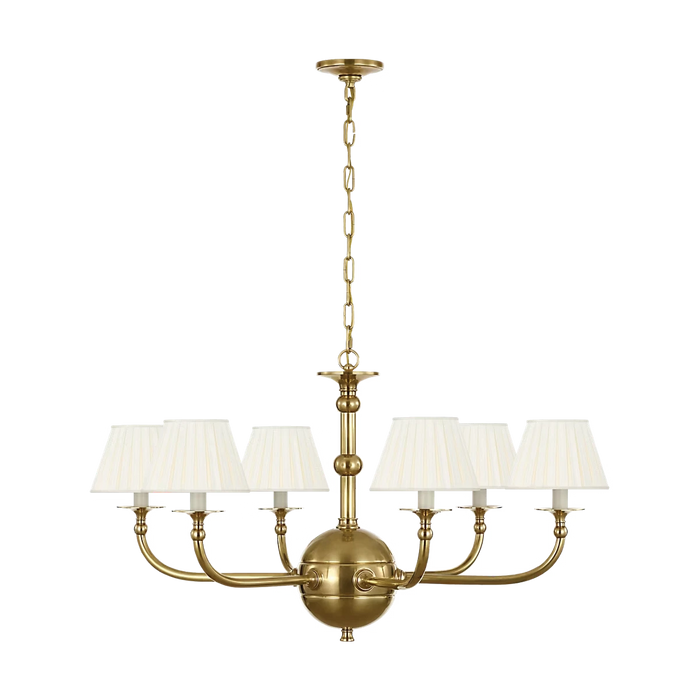 Acres Market & Interiors Embers 41" brass chandelier with five cream pleated shades and a central globe.