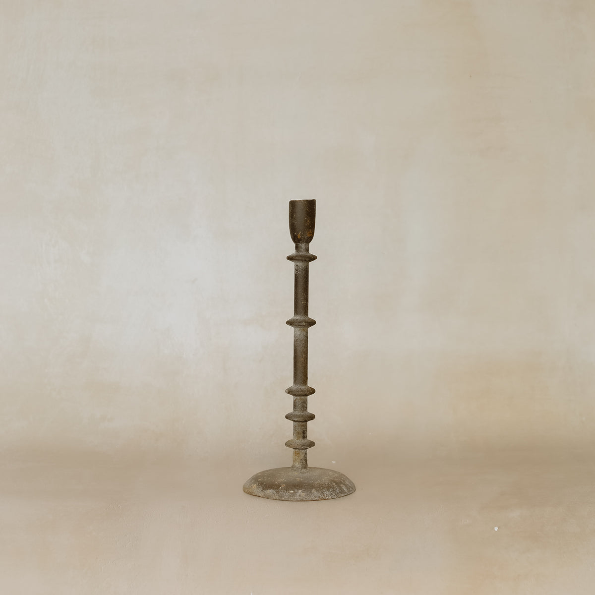Bronze candlestick on a beige background