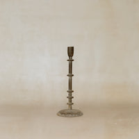 Bronze candlestick on a beige background