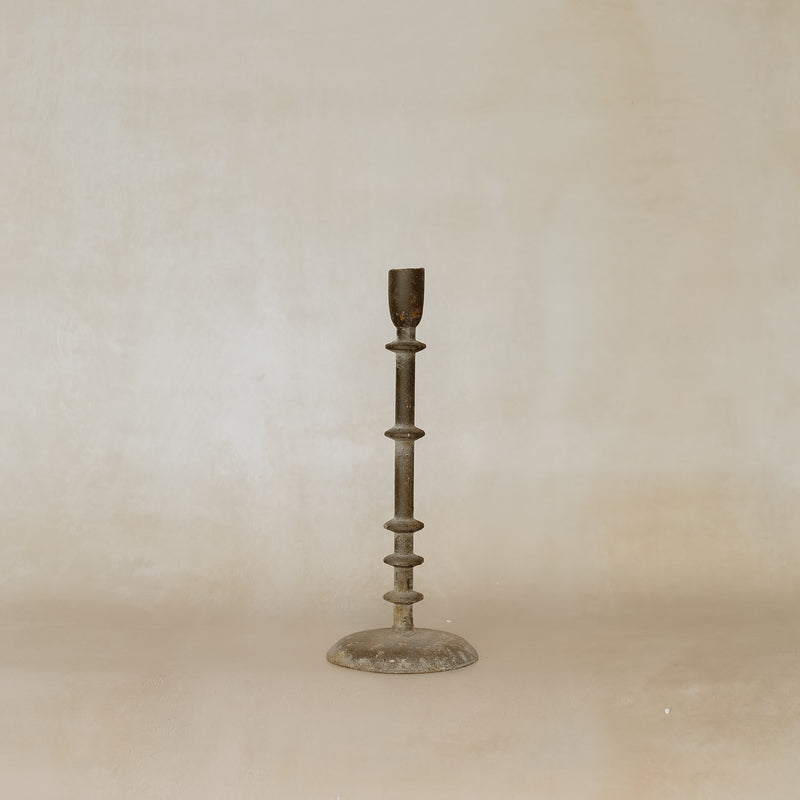 Bronze candlestick on a beige background